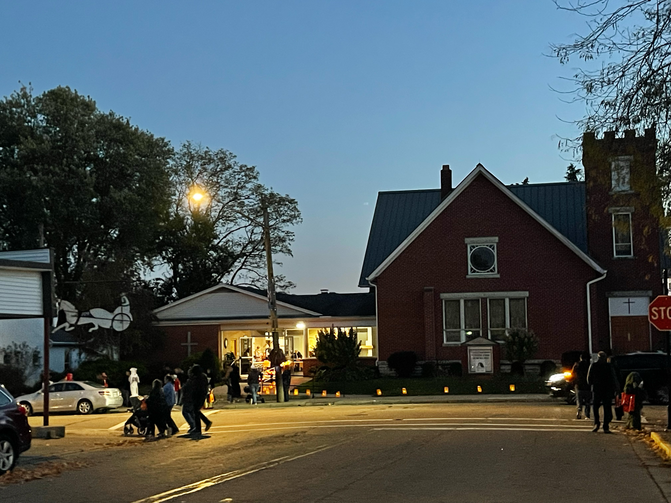 Trick or treaters gather at night outside of church