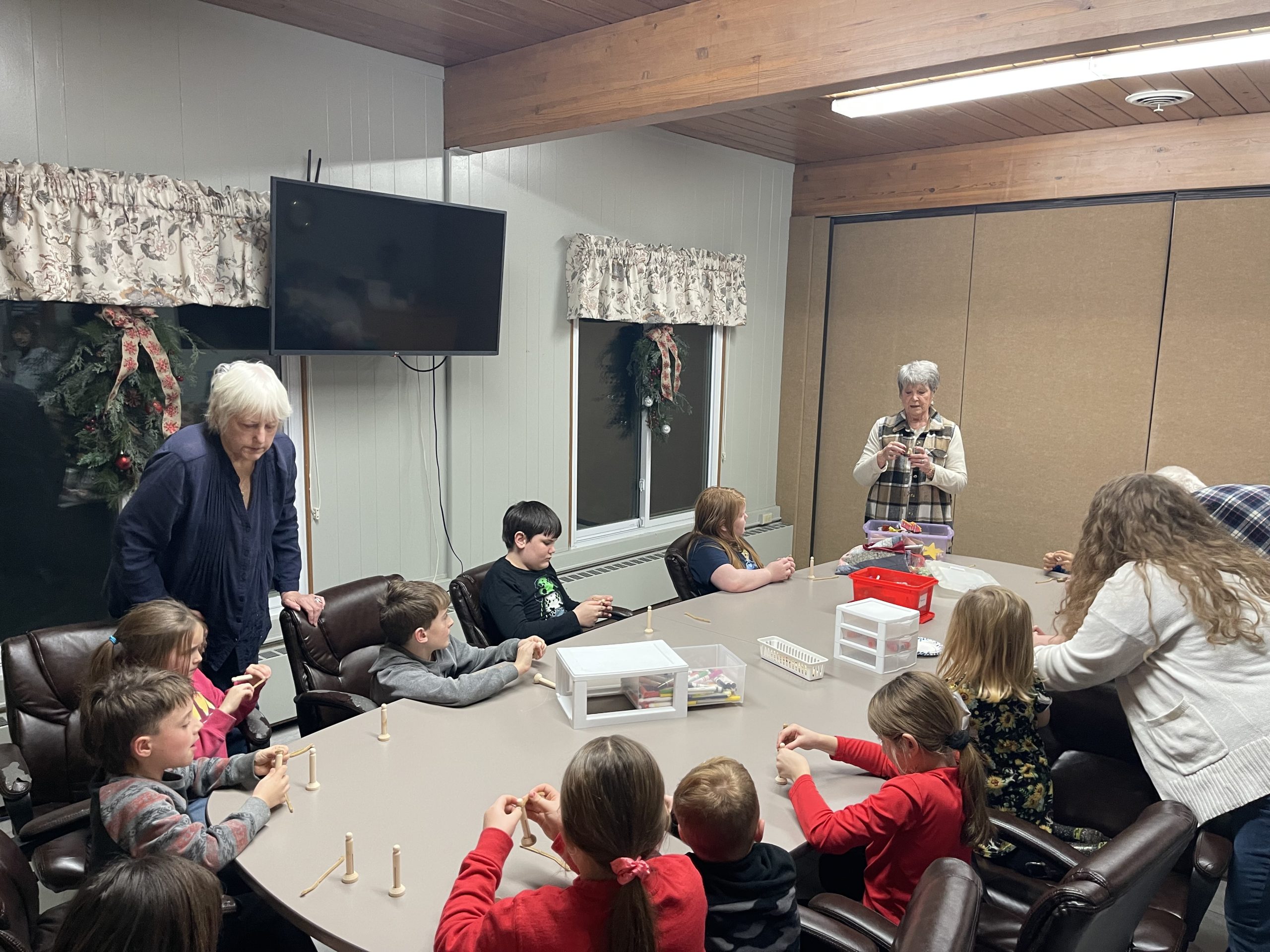Teachers assisting children with crafts