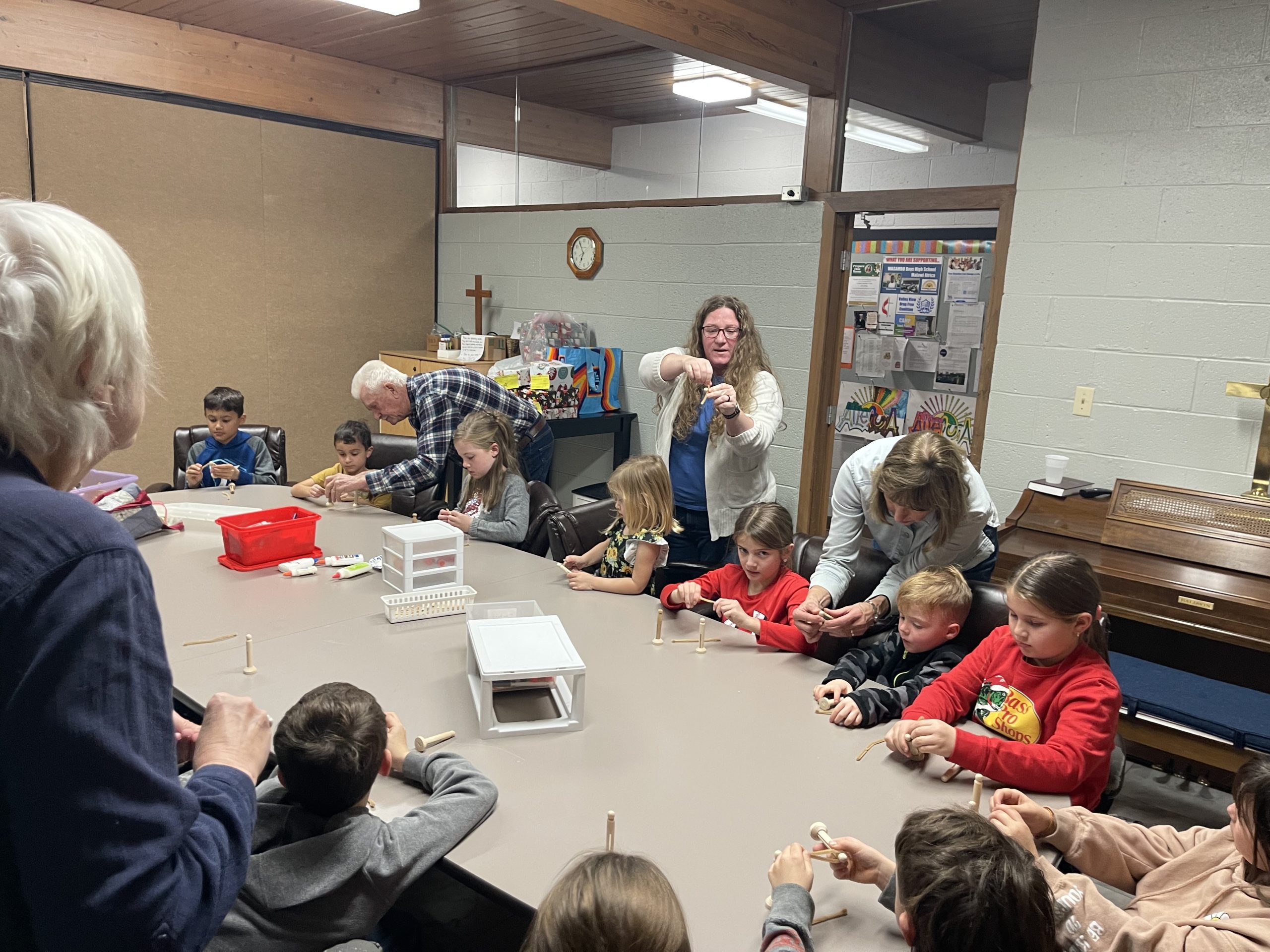 Teachers assisting children with crafts