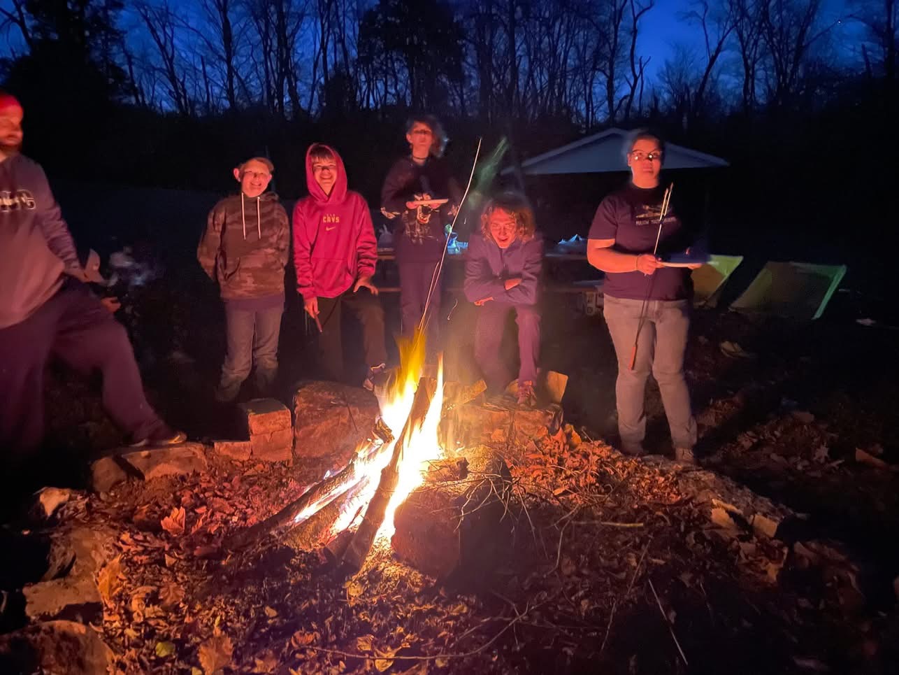 Students gathered around a campfire